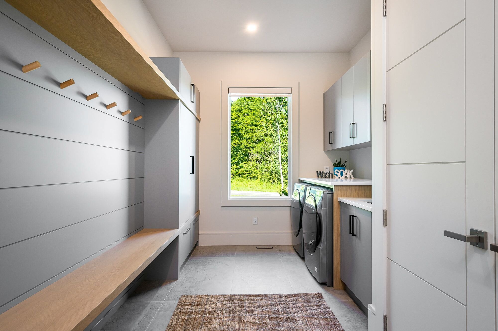 Custom pantry storage with sliding doors and organized shelves designed by Homestead Woodworks for an efficient and stylish kitchen space